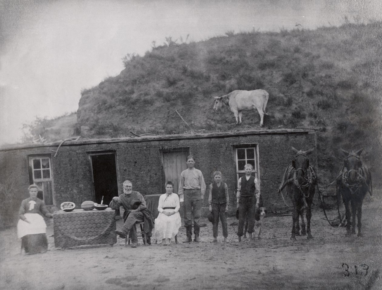 Familia pionera americana frente a su hogar de American Photographer