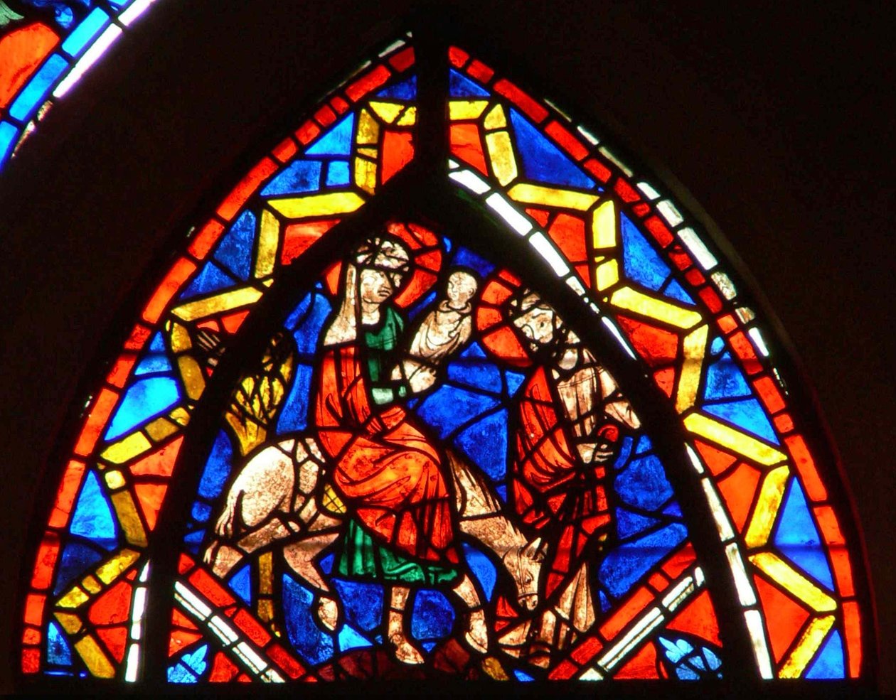 Ventana que representa la Huida a Egipto de French School