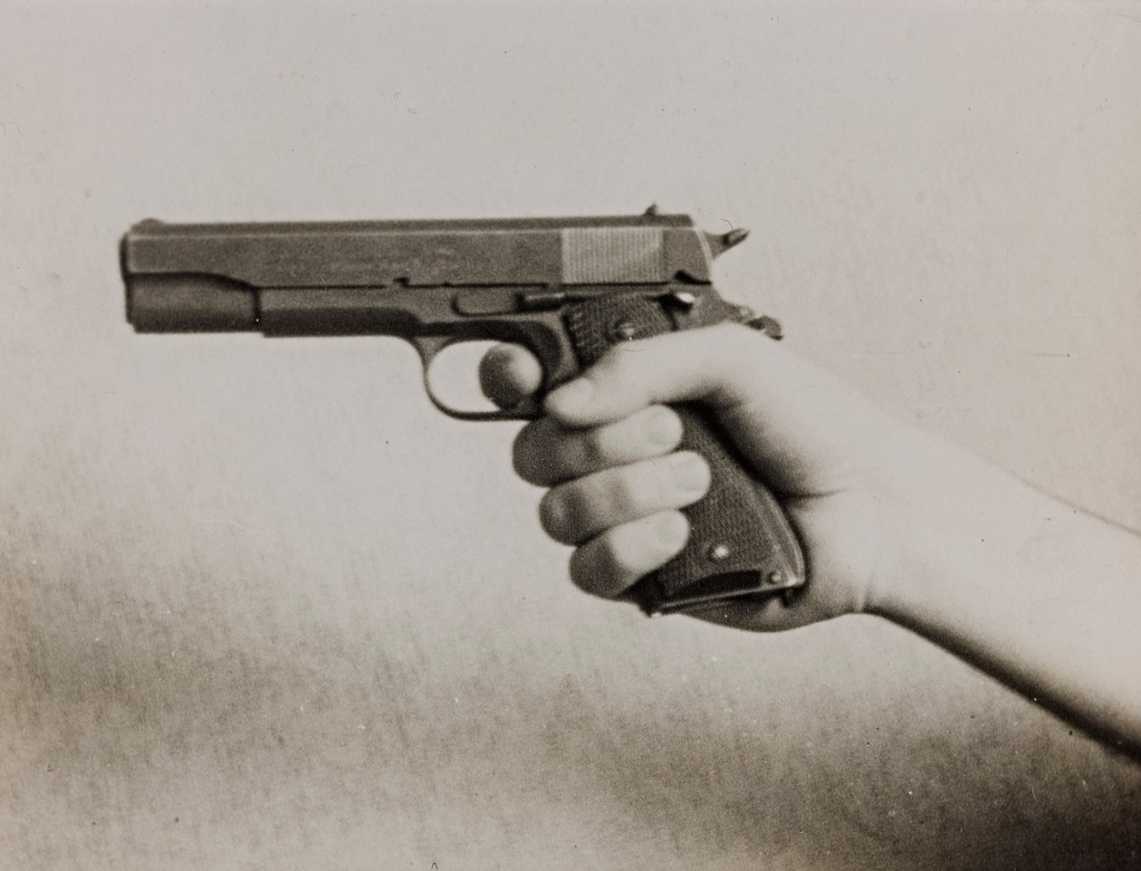 Una mano sosteniendo una pistola automática de Luigi Leoni