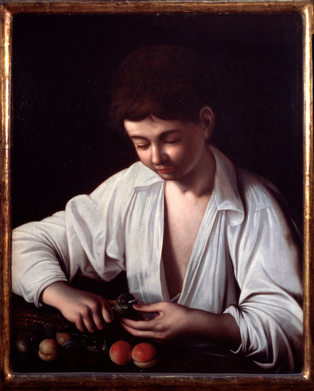 Un niño pelando una fruta de Michelangelo Merisi da Caravaggio