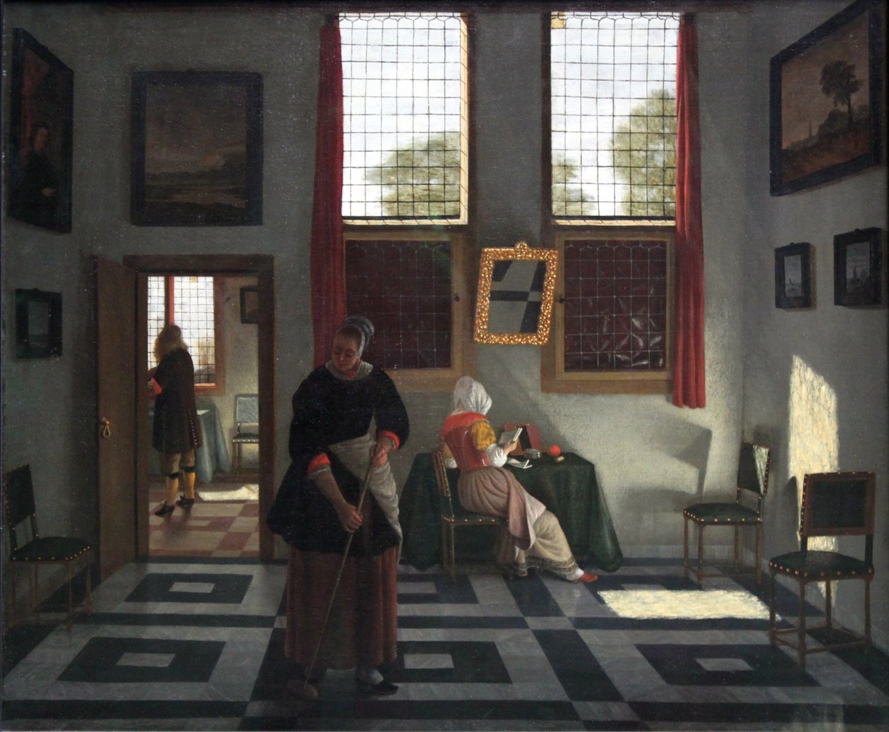 Interior con pintor, dama leyendo y criada barriendo de Pieter Janssens