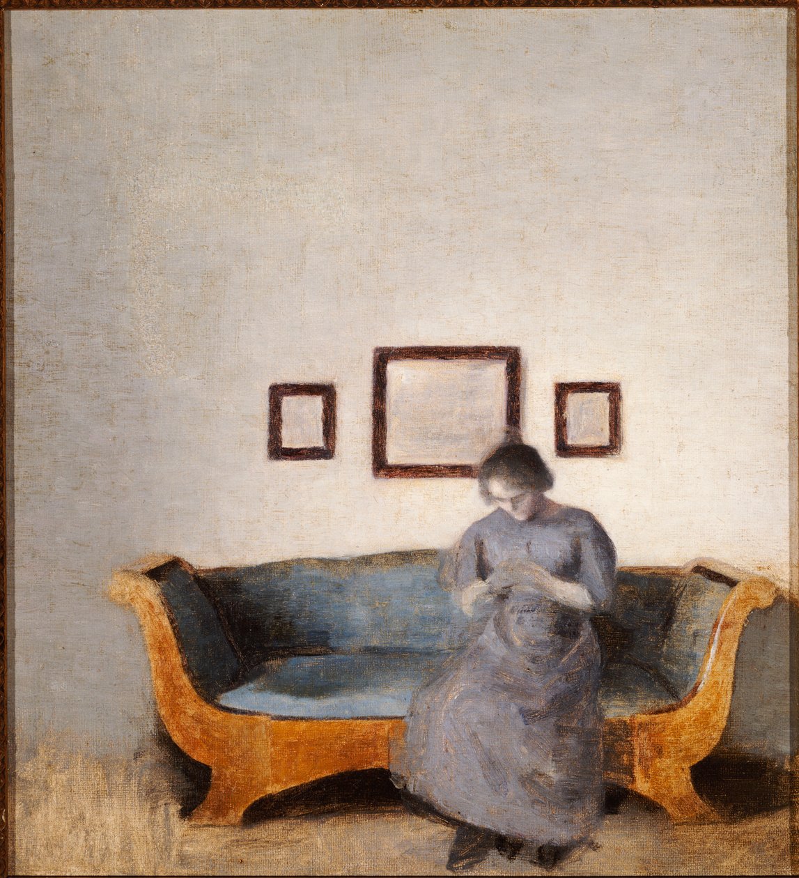 Ida Hammershøi sentada en un sofá de Vilhelm Hammershoi