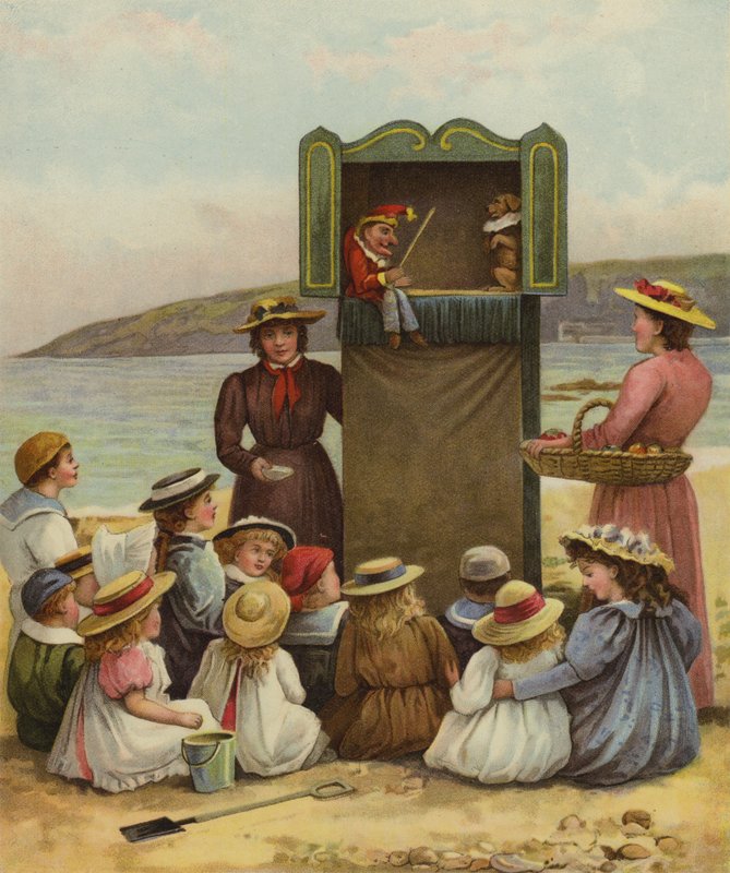 Niños viendo un espectáculo de Punch y Judy en la playa de English School